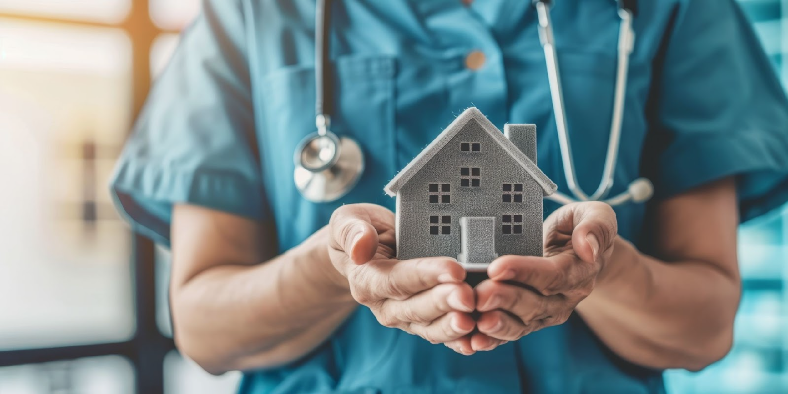 A doctor holding a small model house in their hands, which symbolizes real estate investment and homeownership opportunities for physicians.